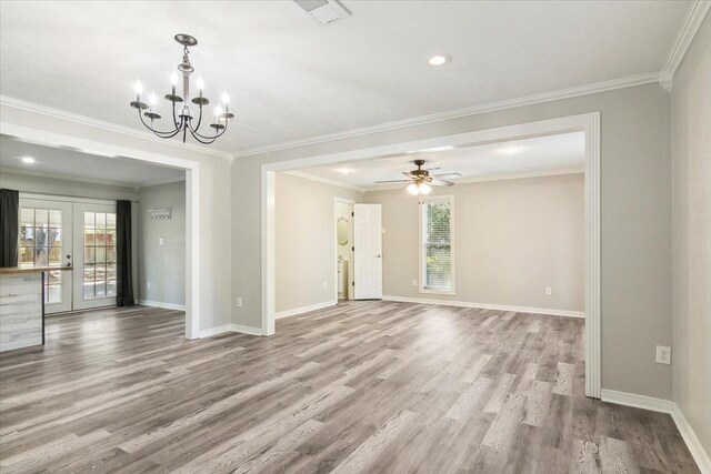 unfurnished living room with a wealth of natural light, french doors, and crown molding