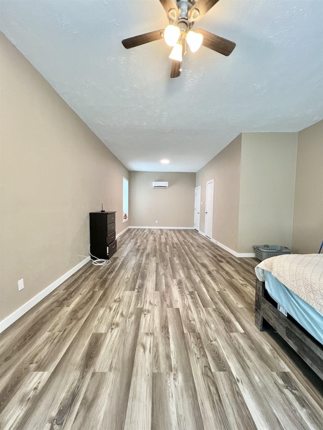 unfurnished bedroom featuring baseboards, ceiling fan, and wood finished floors