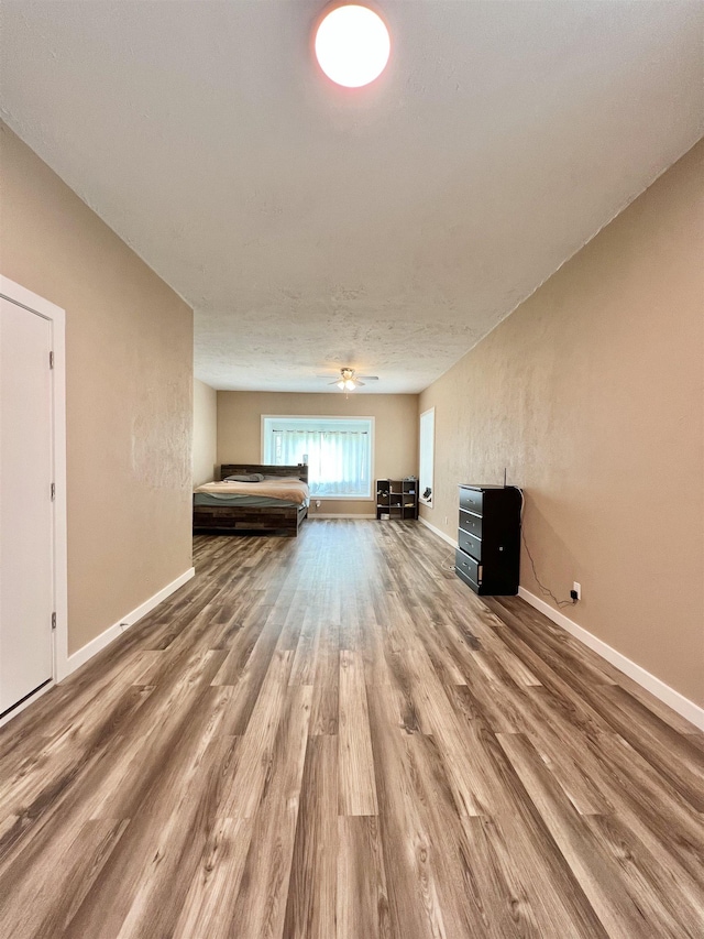 unfurnished bedroom featuring baseboards and wood finished floors
