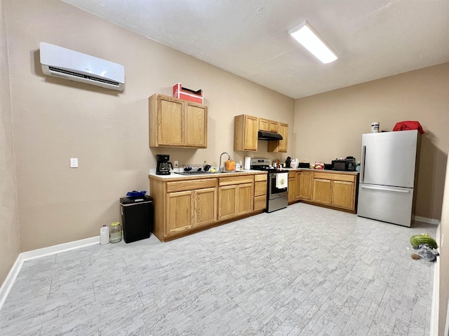 kitchen featuring stainless steel appliances, an AC wall unit, under cabinet range hood, baseboards, and a sink
