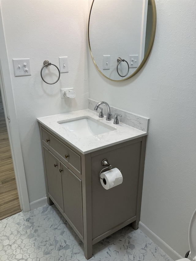 bathroom featuring baseboards and vanity
