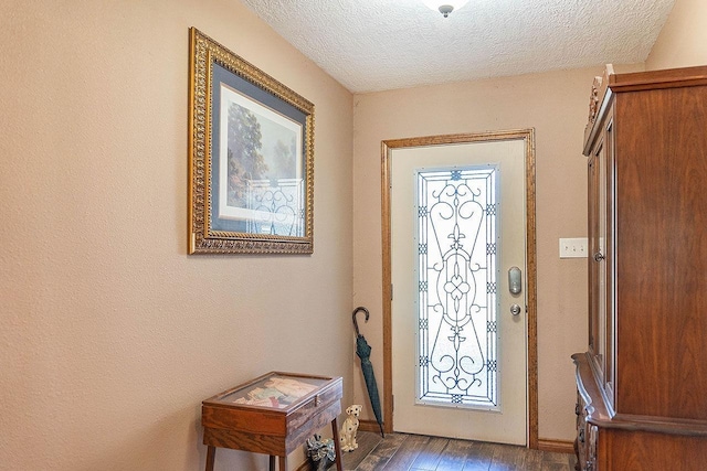 foyer featuring dark hardwood / wood-style flooring and a textured ceiling