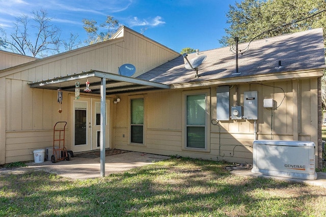 rear view of property featuring a patio and a lawn