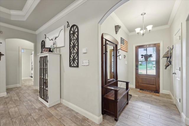 1457 Elizabeth Stone Dr, Bridge City, TX 77611 - entrance foyer with arched walkways, a notable chandelier, wood tiled floor, and crown molding