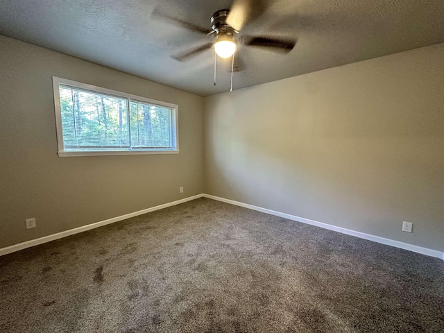 carpeted spare room featuring ceiling fan and a textured ceiling