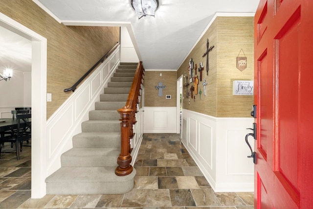 1280 Cherokee Ln, Beaumont, TX 77702 - foyer featuring dark stone finish flooring, stairway, a wainscoted wall, and a decorative wall