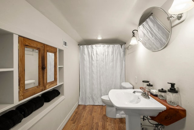 1280 Cherokee Ln, Beaumont, TX 77702 - bathroom with wood finished floors and a shower with shower curtain