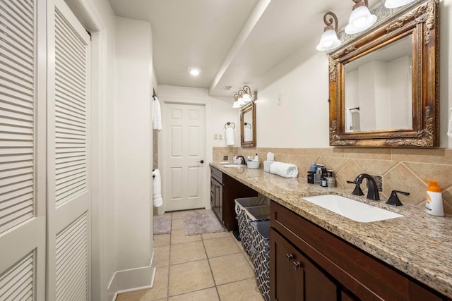 1280 Cherokee Ln, Beaumont, TX 77702 - full bath featuring double vanity, a closet, tile patterned floors, and tasteful backsplash