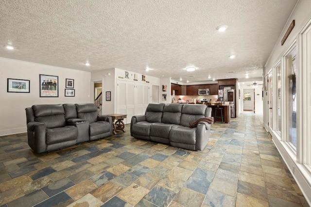 1280 Cherokee Ln, Beaumont, TX 77702 - living room featuring stone tile flooring, a textured ceiling, recessed lighting, and stairs