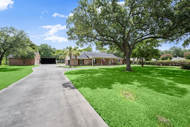 1280 Cherokee Ln, Beaumont, TX 77702 - ranch-style house featuring a front lawn, concrete driveway, and a garage