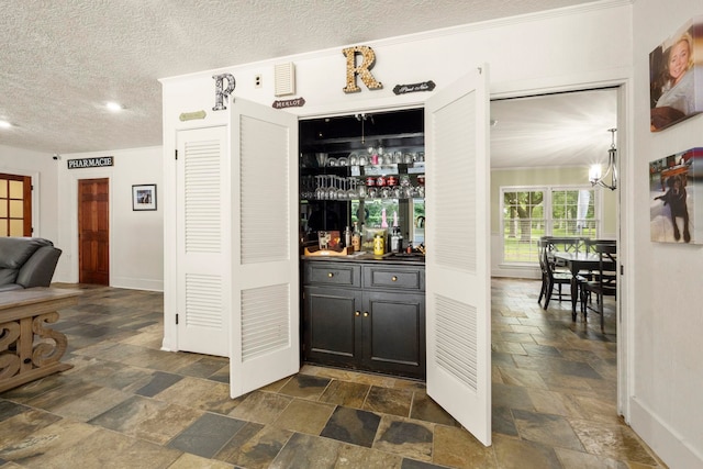 1280 Cherokee Ln, Beaumont, TX 77702 - indoor bar featuring stone tile floors and a textured ceiling