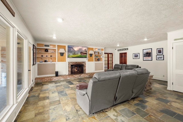 1280 Cherokee Ln, Beaumont, TX 77702 - living area with a textured ceiling, stone finish floors, built in features, recessed lighting, and a fireplace