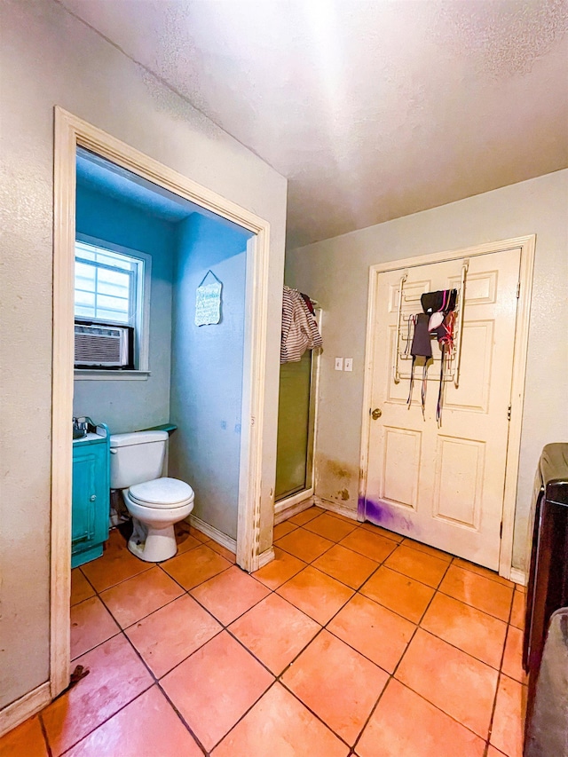 bathroom featuring tile patterned flooring, toilet, and cooling unit