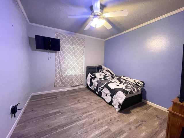 bedroom with ceiling fan, crown molding, a textured ceiling, and hardwood / wood-style flooring