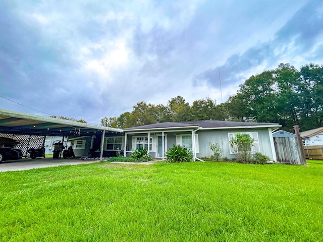 view of front facade with a carport and a front lawn