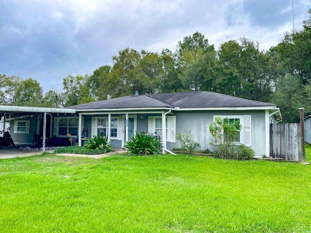 ranch-style home featuring covered porch and a front lawn