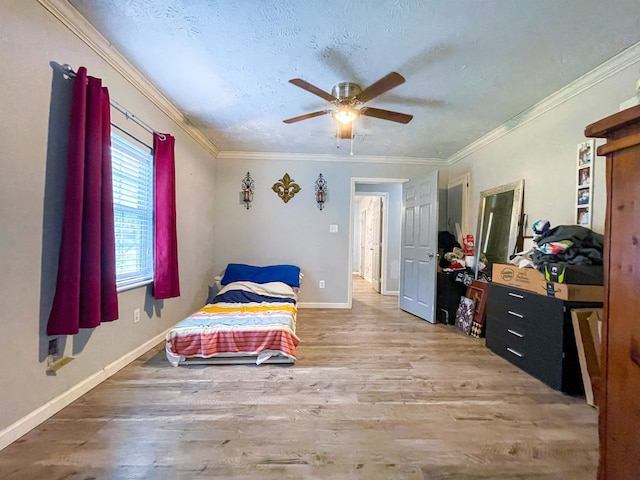 bedroom with hardwood / wood-style flooring, ceiling fan, ornamental molding, and a textured ceiling