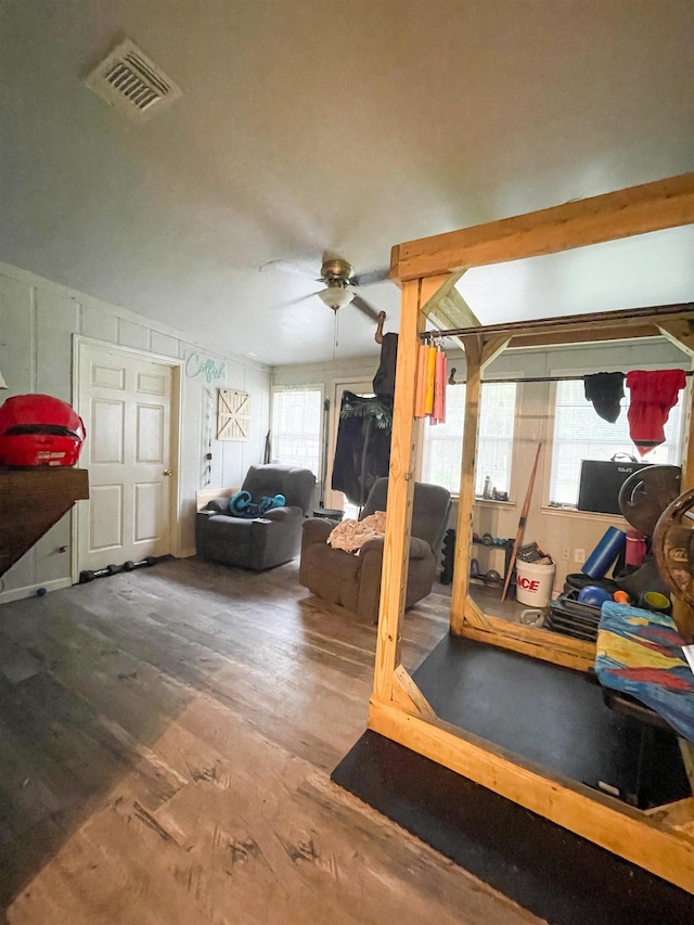 workout area featuring ceiling fan and hardwood / wood-style flooring