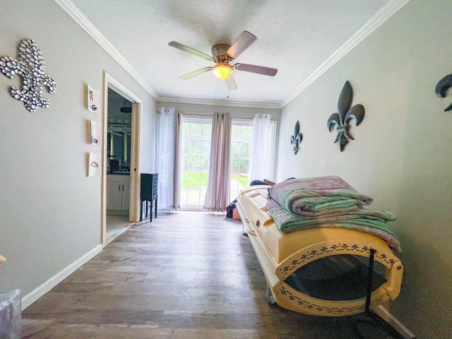 living area with hardwood / wood-style floors, ceiling fan, ornamental molding, and a textured ceiling