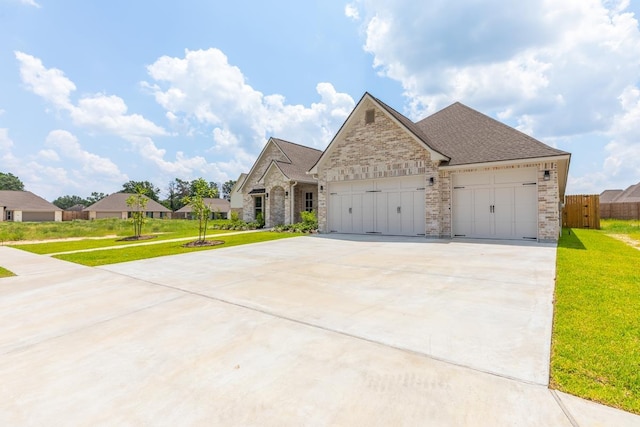 view of front facade featuring a front yard and a garage