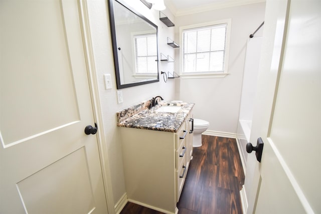 full bath with baseboards, toilet, ornamental molding, wood finished floors, and vanity