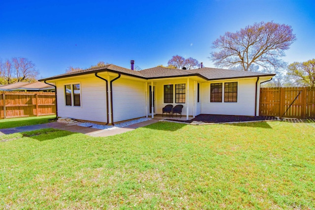 ranch-style house featuring a front lawn and fence