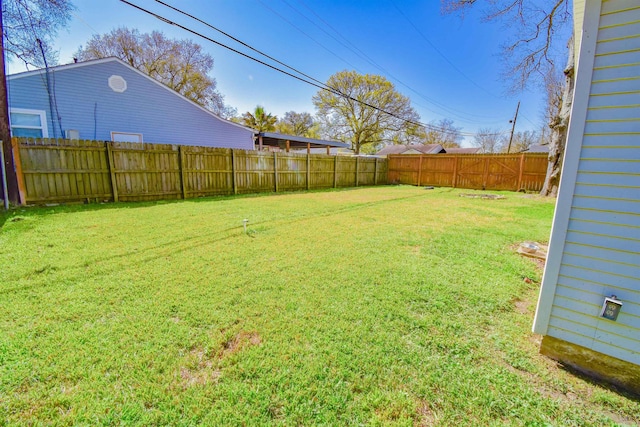 view of yard with a fenced backyard