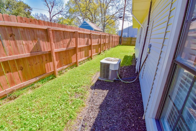 view of yard with cooling unit and a fenced backyard