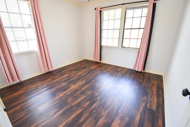 unfurnished room featuring baseboards and dark wood-type flooring