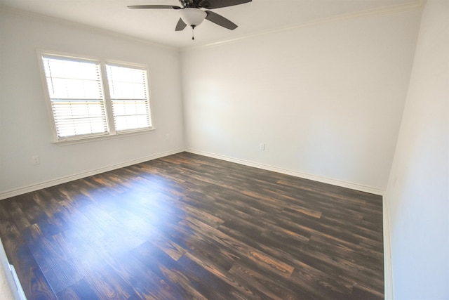 spare room featuring baseboards, ceiling fan, dark wood-style flooring, and ornamental molding