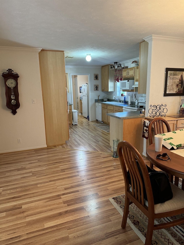 kitchen featuring light brown cabinetry, white appliances, light hardwood / wood-style floors, and crown molding