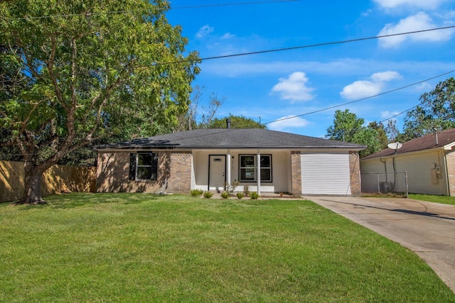 ranch-style house featuring a garage, covered porch, and a front yard