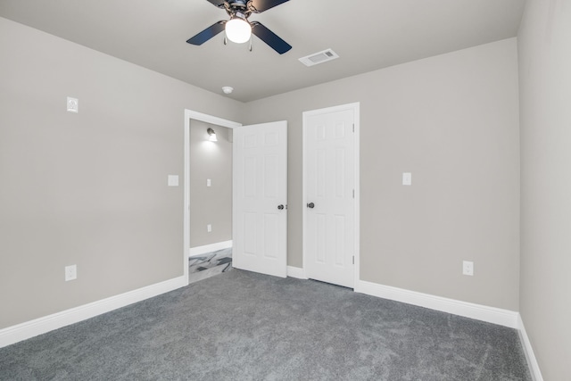 unfurnished bedroom featuring ceiling fan and dark carpet