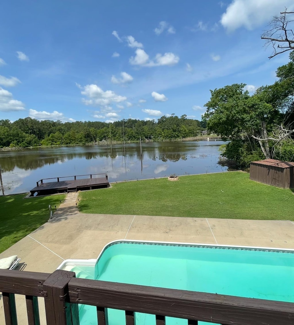607 Cypress Bend Dr, Village Mills, TX 77663 - outdoor pool with a water view, a yard, a boat dock, and a wooded view
