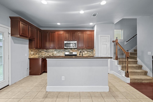 2635 Cedar Spgs, Port Arthur, TX 77630 - kitchen with stainless steel appliances, dark countertops, visible vents, and tasteful backsplash