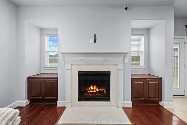 2635 Cedar Spgs, Port Arthur, TX 77630 - room details featuring baseboards, a fireplace with flush hearth, and wood finished floors