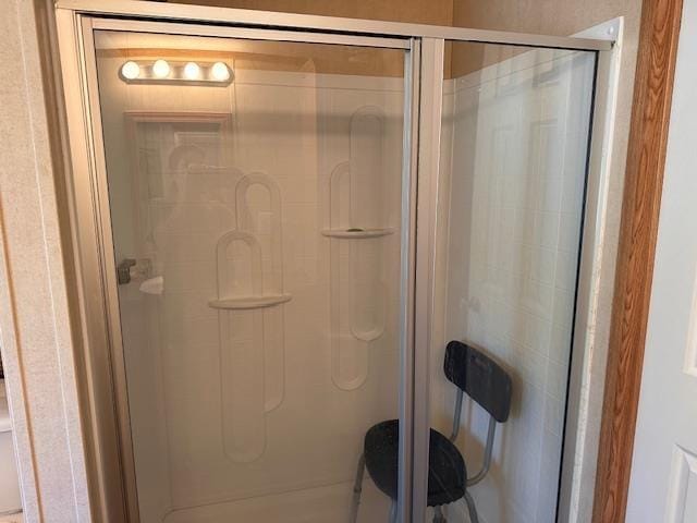 bathroom with a shower with door