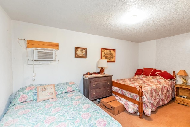 bedroom featuring carpet, a textured ceiling, and a wall unit AC