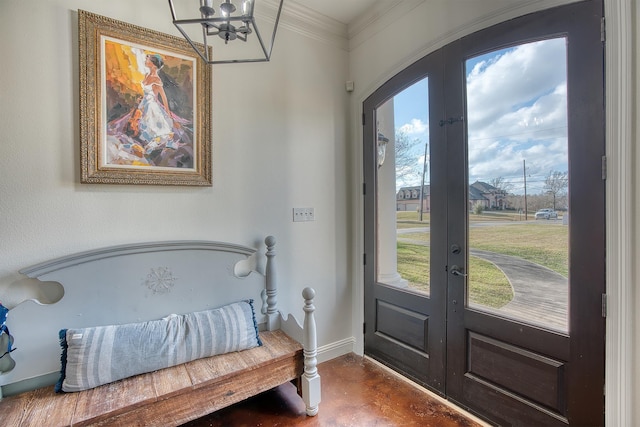 interior space featuring french doors, ornamental molding, and an inviting chandelier