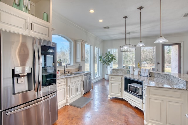 kitchen with stainless steel appliances, decorative light fixtures, light stone countertops, and sink