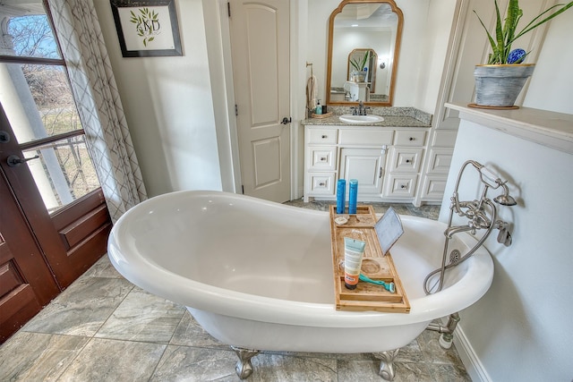 bathroom featuring vanity and a bath