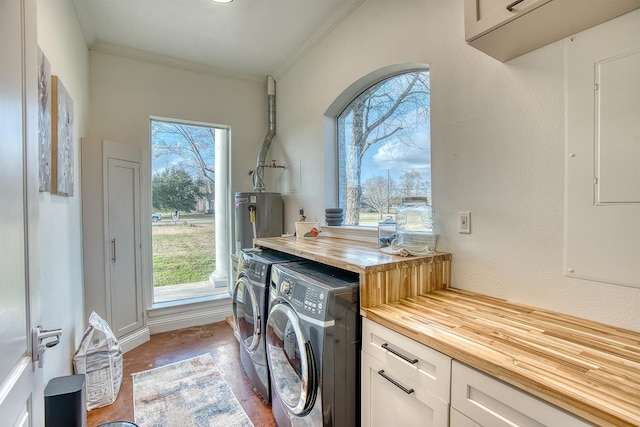 laundry area featuring cabinets, gas water heater, ornamental molding, and washer and dryer