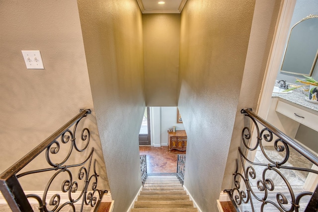 stairway featuring hardwood / wood-style flooring and ornamental molding