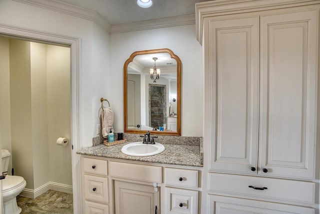 bathroom with vanity, ornamental molding, and toilet