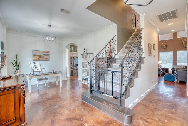 stairway with concrete flooring and crown molding