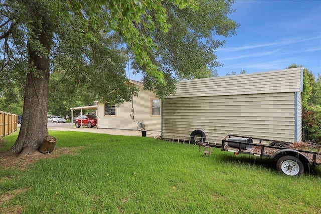 595 Blanton Pl, Beaumont, TX 77707 - back of property featuring a lawn and a carport
