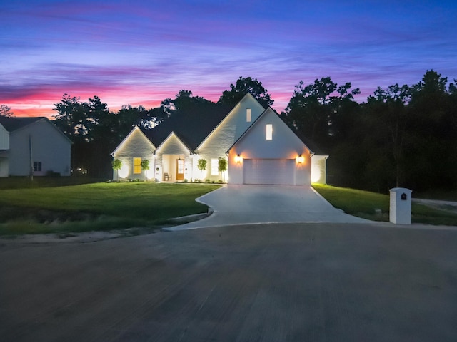 view of front facade with a lawn and a garage