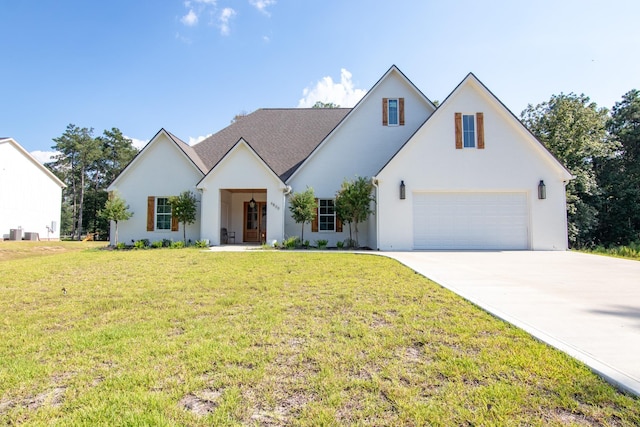 modern inspired farmhouse with an attached garage, driveway, and a front yard