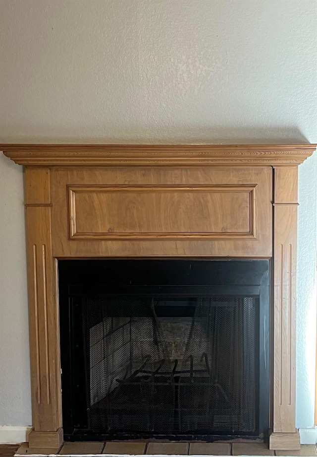 room details with a textured ceiling and a fireplace