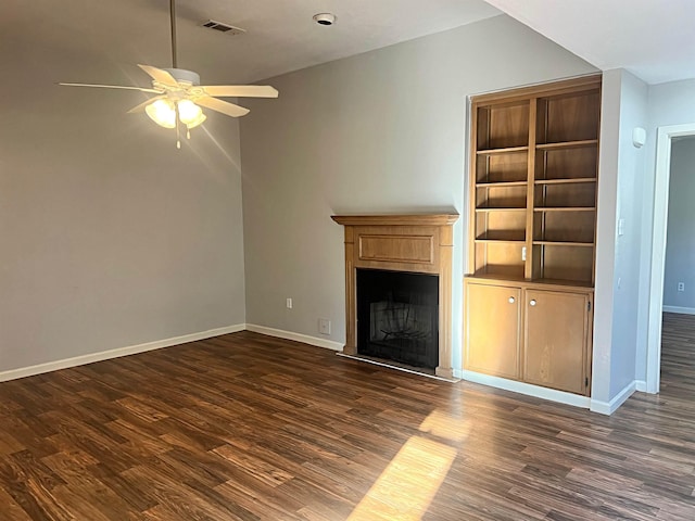 unfurnished living room with dark wood finished floors, a fireplace with raised hearth, visible vents, ceiling fan, and baseboards